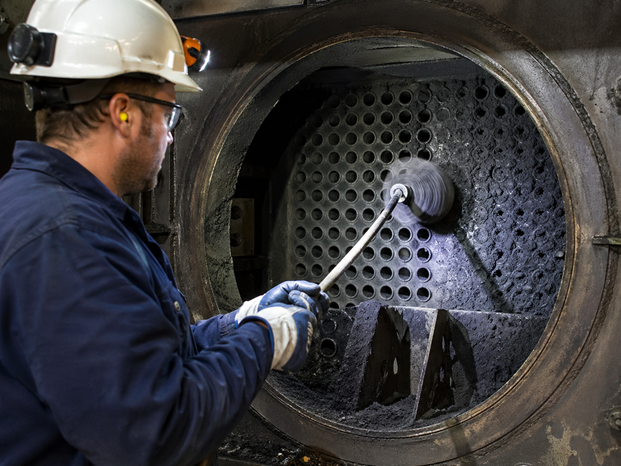 urnace cleaning technician using advanced tools to improve HVAC system performance